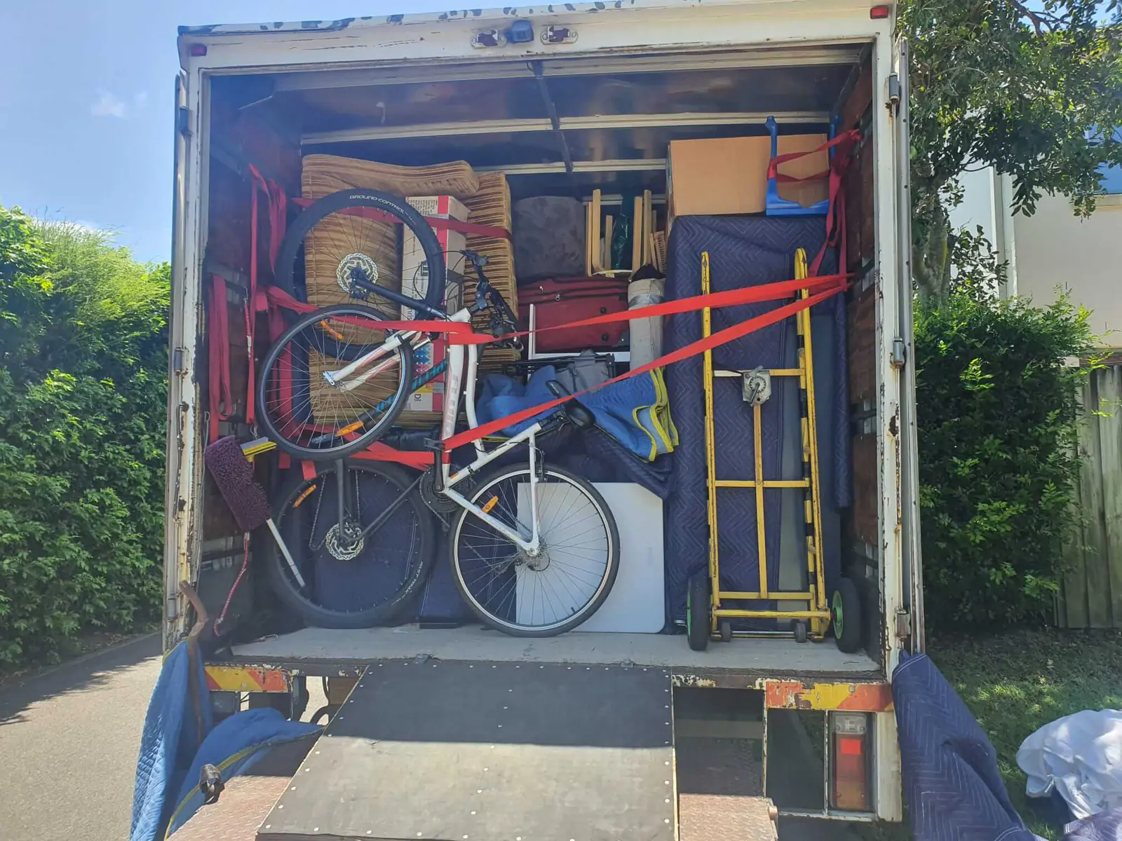 Household items wrapped and secured inside a removal truck