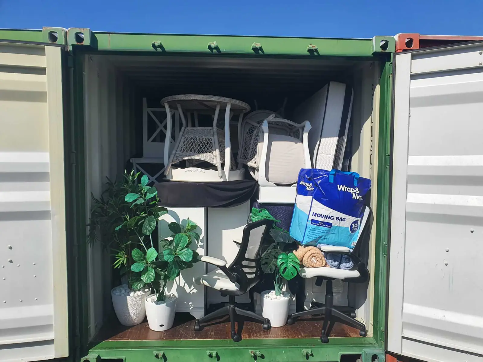 Office furniture packed securely inside a removal truck